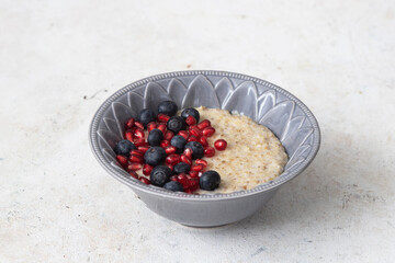 Oatmeal Porridge with berries and pomegranate.Healthy Breakfast