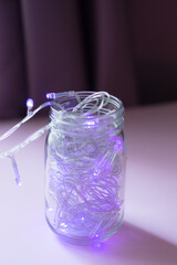 Lights inside the glass jar, colorful light glowing in the dark inside the jar. selective focus