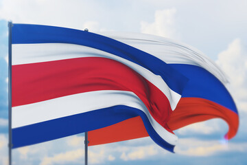 Waving Russian flag and flag of Costa Rica. Closeup view, 3D illustration.