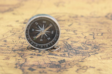 round compass on background of birch bark as symbol of tourism with compass, travel with compass and outdoor activities with compass