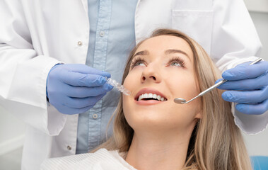 Woman having teeth examined at dentists