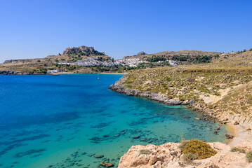 Fototapeta na wymiar A picturesque Bay with blue water near the village of Lindos, Rhodes island, Dodecanese, Greece.