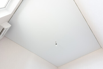 Stretch white ceiling in a rectangular room