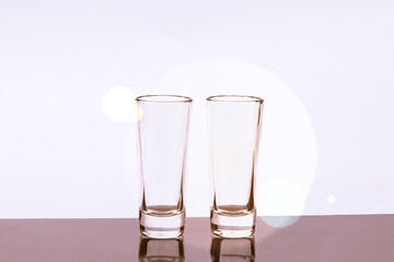 daylight. glass on a burgundy background. Reflection in the shadow. Copy space. text.