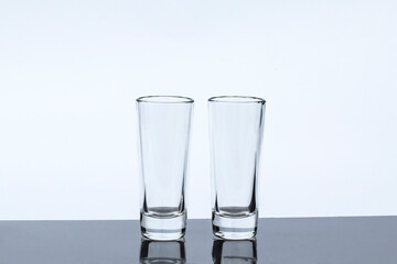 daylight. glass on a burgundy background. Reflection in the shadow. Copy space. text.