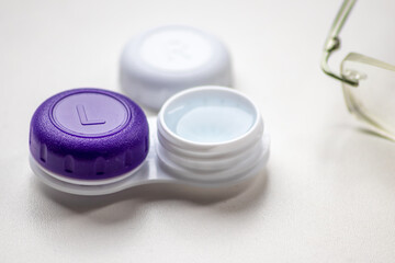 Contact lens container with contact lenses as optic alternative to glasses correct eyesight diseases like farsightedness and nearsightedness from a optician or eye doctor with medical hygiene concept