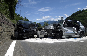 Car crash accident with deadly motorist in frontal collision between two cars on the road.  Fatal car accident in the night.