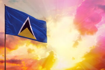 Fluttering Saint Lucia flag in top left corner mockup with the space for your text on beautiful colorful sunset or sunrise background.
