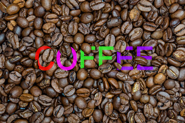 inscription coffee on the background of coffee beans