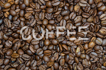 inscription coffee on the background of coffee beans