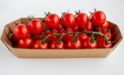 Cherry tomatoes on a branch in eco-friendly packaging