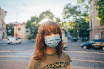 Happy young woman wearing medical face mask for virus protection