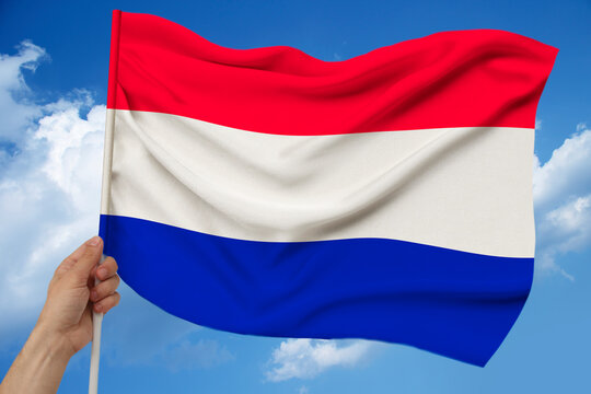 photo of the beautiful colored national flag of the modern state of the Netherlands on textural fabric, concept of tourism, economics and politics, closeup