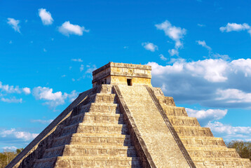 Fototapeta na wymiar Maya pyramid of Kukulkan (El Castillo) in Chichen Itza during the summer solstice, with the shadows of the feathered snake Quetzalcoatl by the stairs left, Yucatan, Mexico.