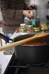 young woman cooking salsa on a Sunday