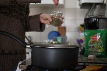 young woman cooking salsa on a Sunday