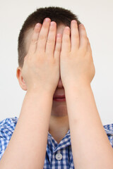 crying child, kid, covering his eyes with fear, shame or resentment, cry and afraid, concept of abuse, outsider in the children&rsquo;s team, bullying, family violence