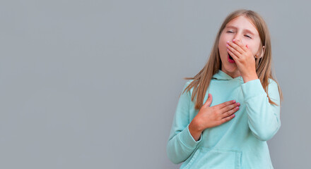 Blonde girl wants to sneeze or yawn isolated on gray background