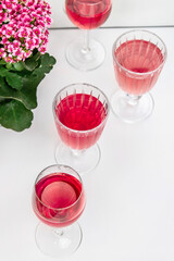 Pink drink in glasses. Pink flowers.