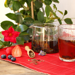 teapot with tea leaves, herbal tea, in the background fruits, dry fruit, berries, flowers, the concept of a healthy diet, diet, vitamin drink, quenching thirst