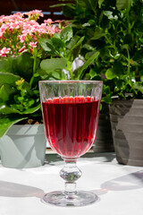 Pink drink in a glass. Pink flowers.