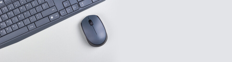 Keyboard and mouse on grey background. Flat lay, overhead view image. Copy space, template.