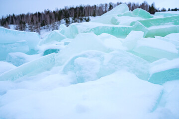 chunks of ice are thrown in the snow on the surface of the reservoir, they made an ice hole