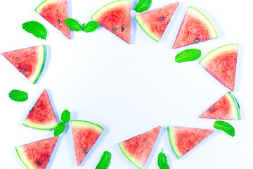 Creative summer food concept. Watermelon pattern. Juicy slices of ripe red watermelon and mint leaves on white background. Flat lay, top view, copy space. Summer berry, healthy nutrition, vitamins