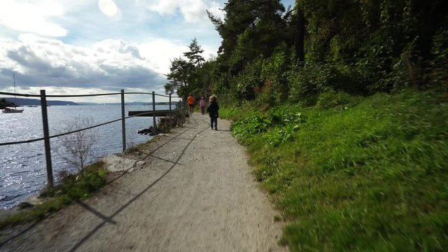Walking on a small track with the family at the deep fjords of Norway. Shot with a gimbal for smooth movements. 