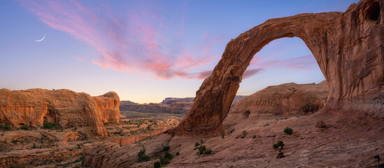 Corona Arch panorama at dusk with crescent moon