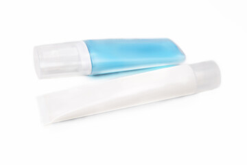 Two bottles of cream, lotion for sensitive skin, body care products isolated on white background