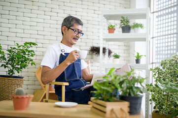An elderly man is relaxing with coffee and reading Newspaper at his home .