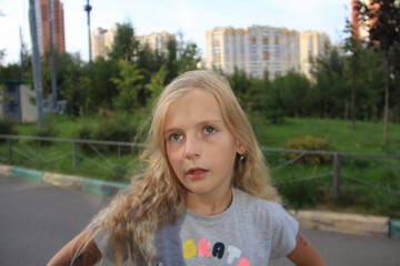 Blonde girl with blue eyes makes grimaces