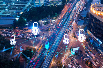 Naklejka na ściany i meble Padlock icon hologram on aerial view of road, busy urban traffic highway at night. Junction network of transportation infrastructure. The concept of success in cyber security intelligence.
