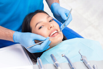 dentist examines the patients teeth at the dentist. close up