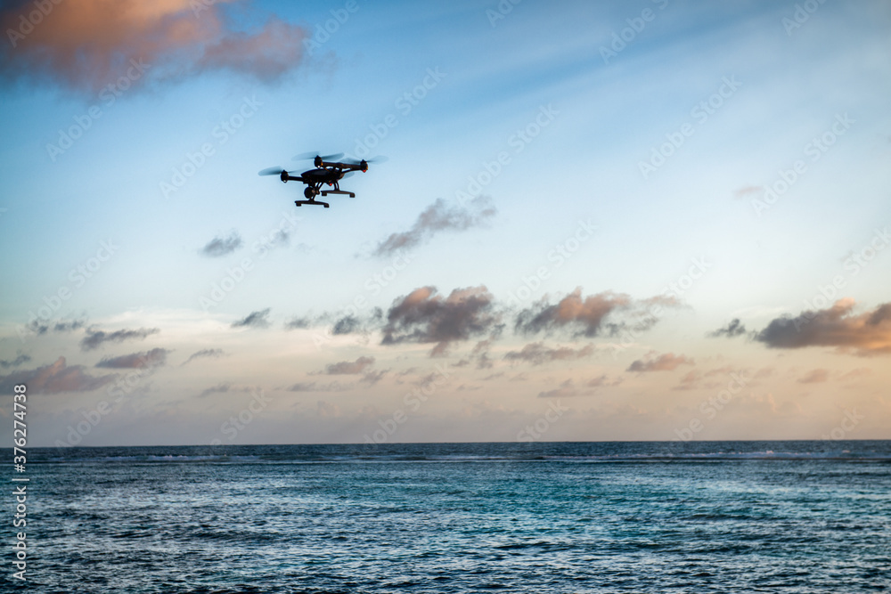 Poster drone silhouette flying over a tropical island. vacation, travel and discovery concept