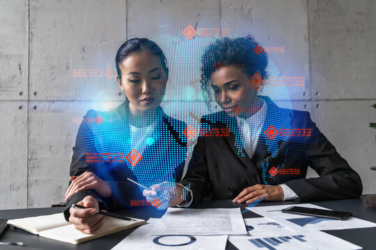 Two businesswomen work together in modern office on new project. Double exposure. Concept of success. Planet earth world map. - Powered by Adobe