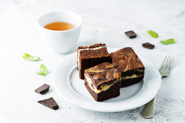 Cream cheese chocolate brownie with mint leaves