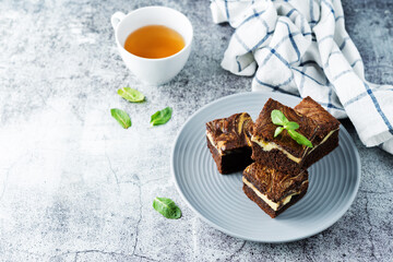 Cream cheese chocolate brownie with mint leaves