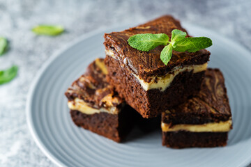 Cream cheese chocolate brownie with mint leaves