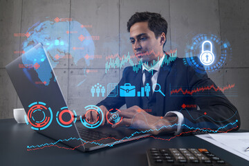 Businessman in office working with laptop, develop fintech approach to business, typing computer assemble data for new opportunities. Double exposure.