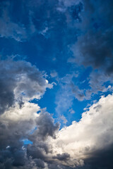 White and dark clouds on the blue sky
