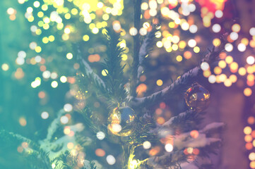 Christmas tree branches with balls and blurry lights background. Design for your ad, poster, banner
