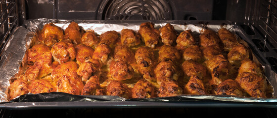 Chicken wings baked in the oven to crispy crust. Chicken BBQ. Home cooking concept.