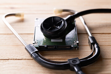 diagnosis and data recovery concept. backup information hard disk drive over wooden background....