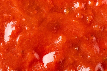 Ketchup or tomato sauce macro texture background.
