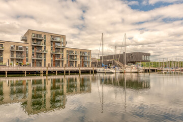 waterfront apartments and sailingboats reflecting in the harbour