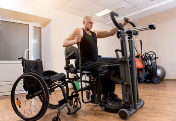 Disabled man training in the gym. Rehabilitation center