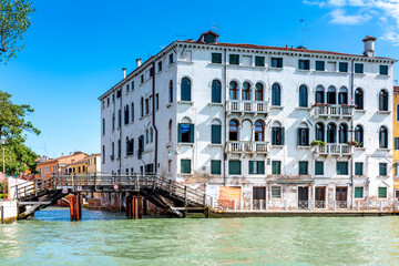 Fototapeta premium Tenement house and water canal in Venice, Italy