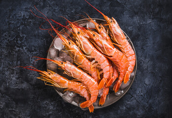 Wild red shrimps, ocean raw jumbo shrimps on dark background copy space. - 376282197